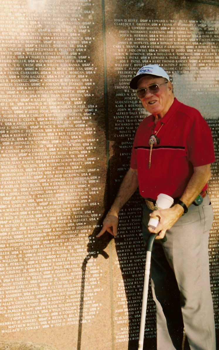 Dr. Cooper points to his name at the Brazos Valley Veterans' Memorial